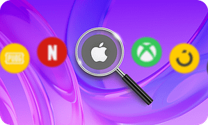 Magnifying glass focusing on Apple gift card logo surrounded by other digital gift card icons including Netflix, Xbox, PUBG, and Smile on a purple background